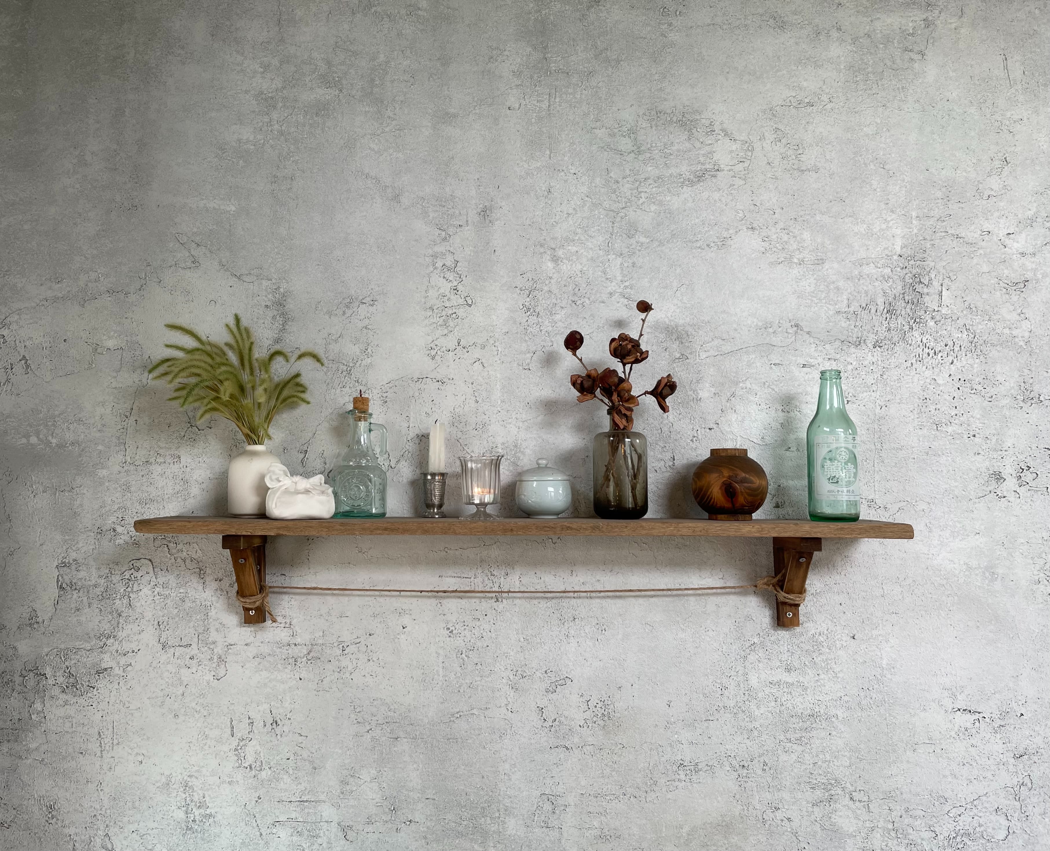 green glass bottles on brown wooden wall rack