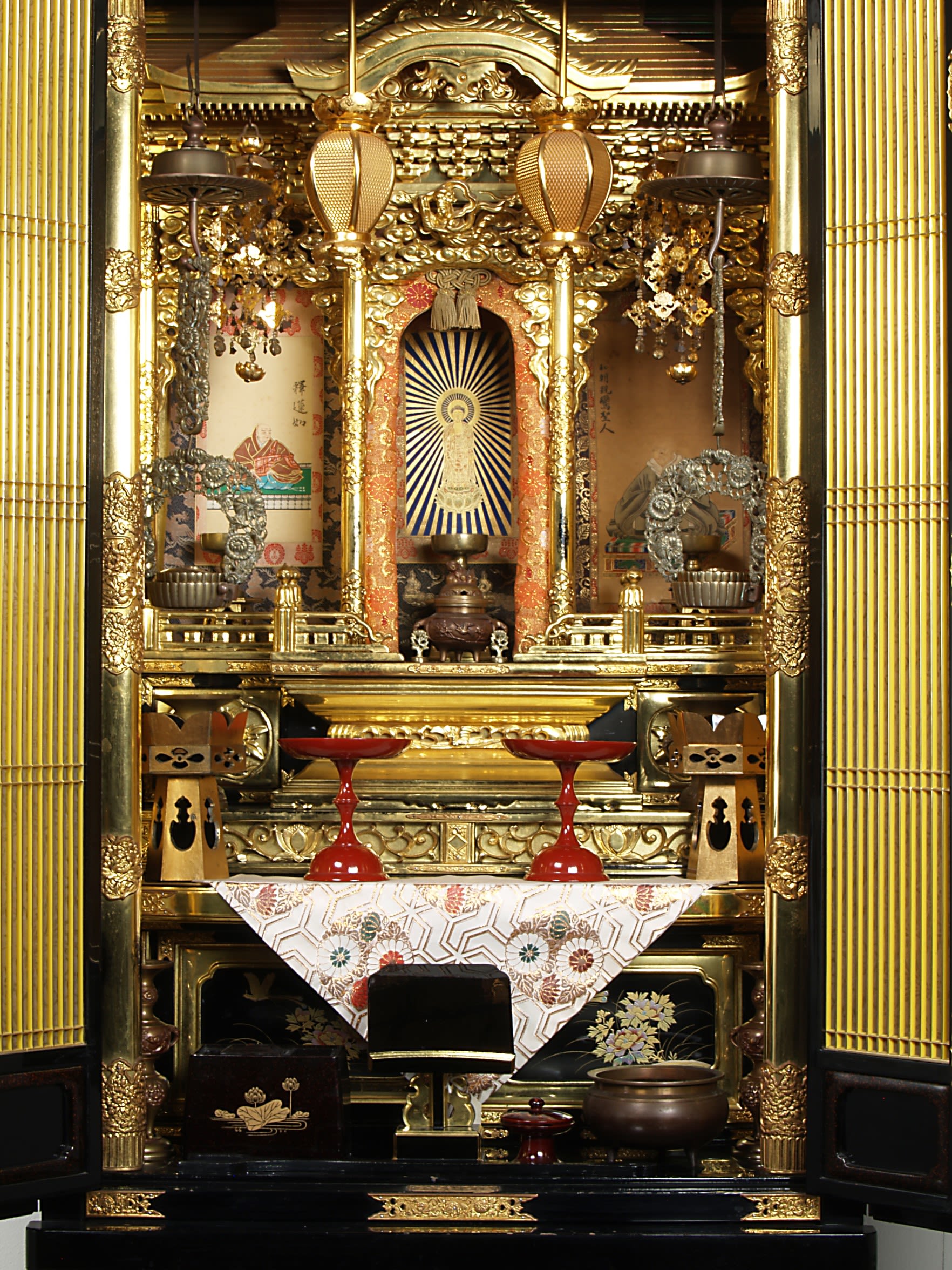 Inside of a Japanese Buddhist altar showing many ornaments and decorations.