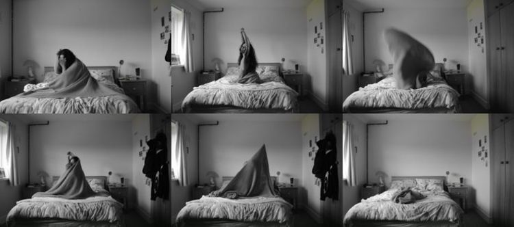 Six black and white photos of a person in a bedroom. They are on the bed in the centre of each image moving under a blanket, in a different pose in each image.