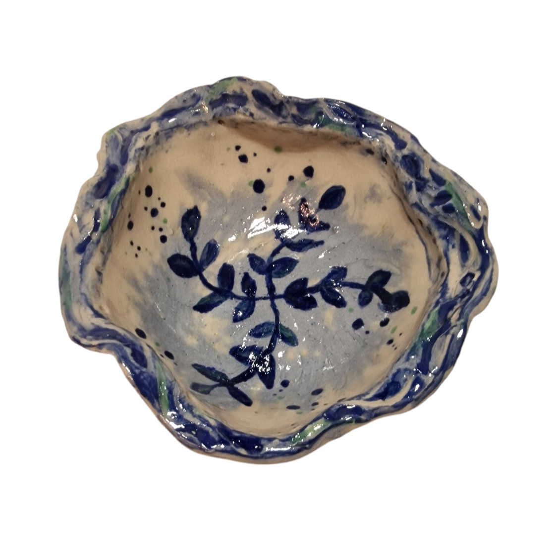 Above view of hump made stoneware bowl with blue vine like illustration inside