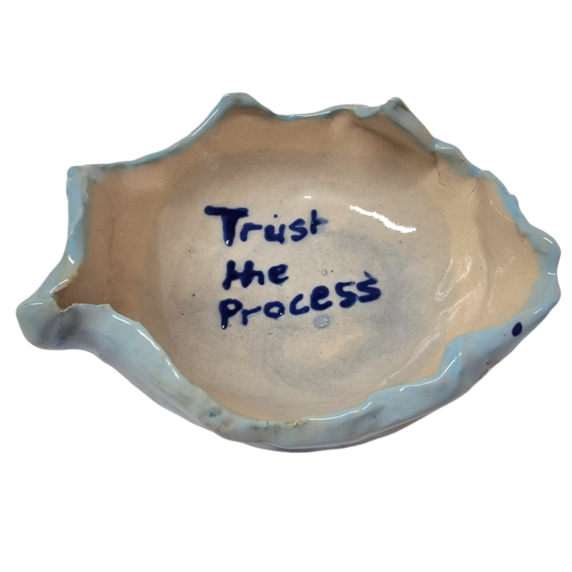 Above view of hump made stoneware bowl with text in the middle reading: Trust the Process