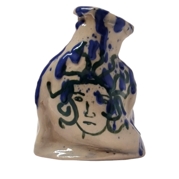 Hand built bottle with blue splatter pattern and green face