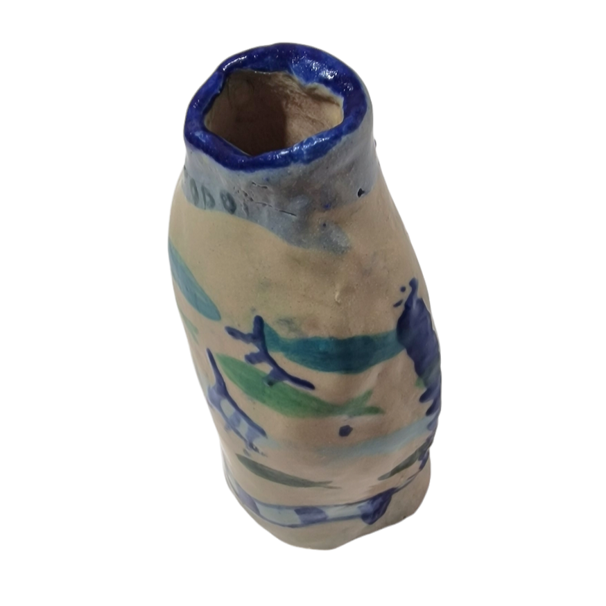 Hand built blue bottle with abstract blue and green patterns