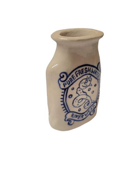 A white stoneware bottle with blue hand-illustrated image of a cat-like Lambton Worm. The illustration is surrounded by text in a banner ribbon that reads: Pure Fresh Water. River Wear.