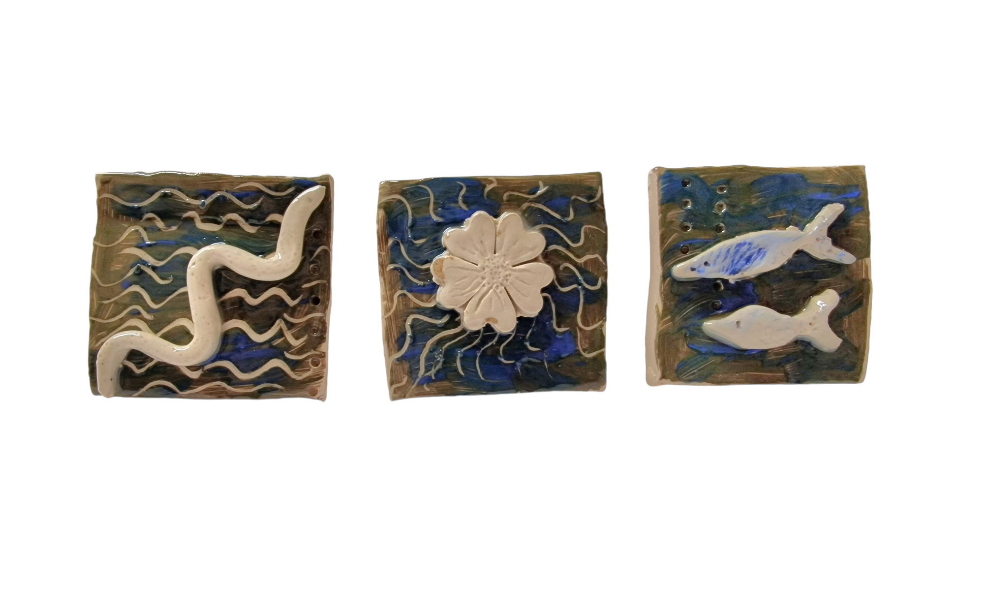 Three square tiles show worm like creature, flower and two fishes in blue and muddy green