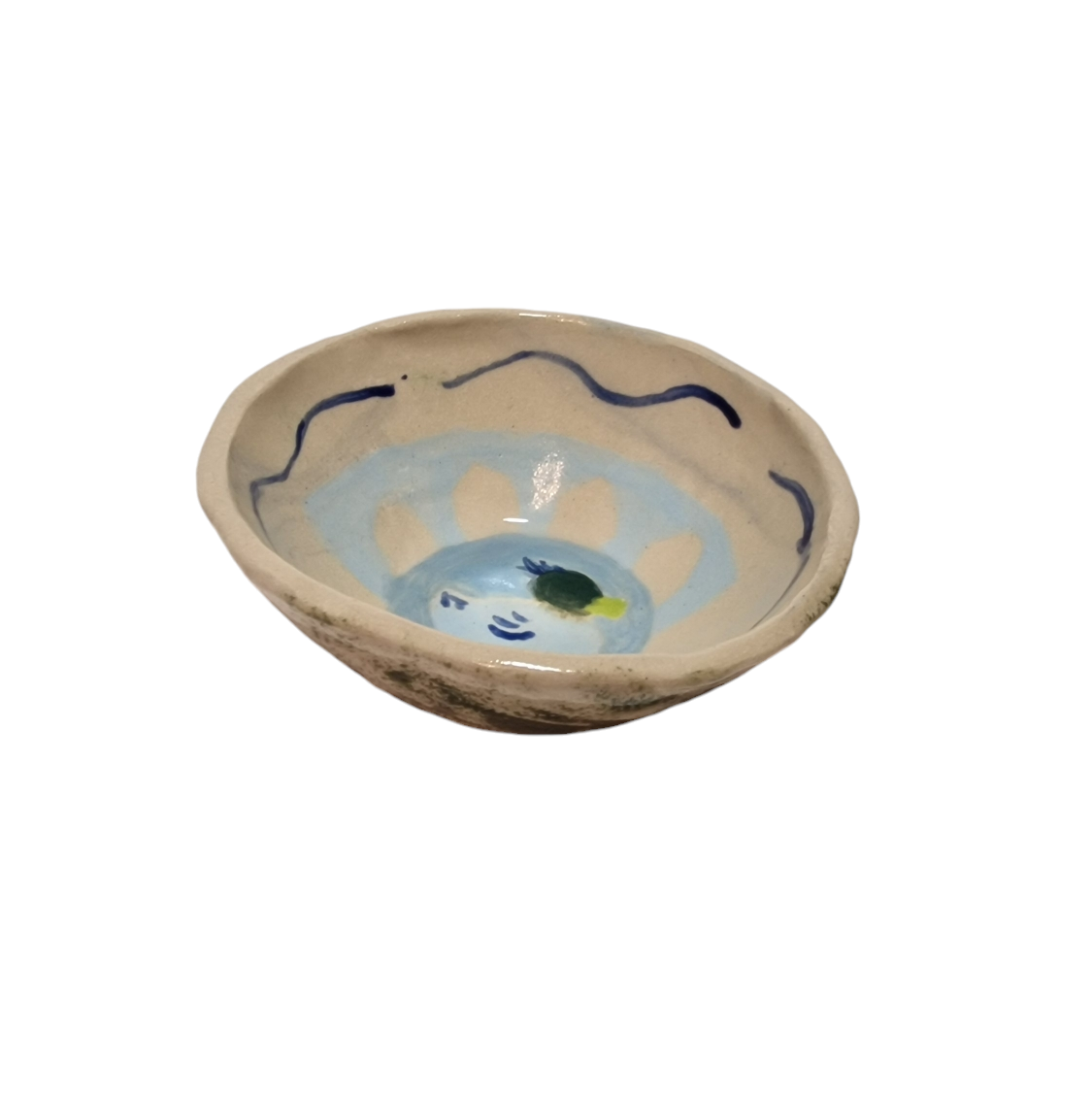 Above view of hump made stoneware bowl with abstract blue and green shapes