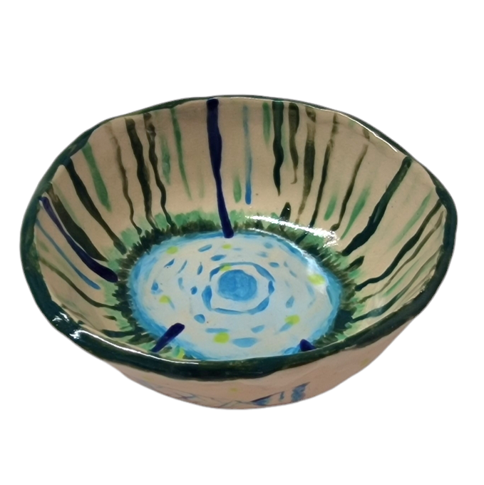 Above view of hump made stoneware bowl with abstract blue and green lines and illustration on pooling water in the center