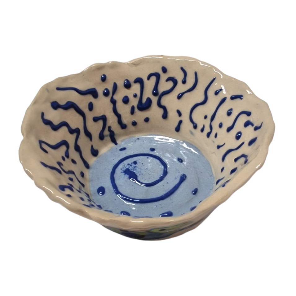 Above view of hump made stoneware bowl with abstract blue lines and swirls