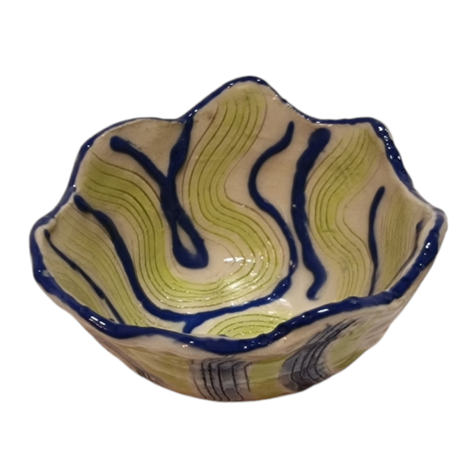 Above view of hump made stoneware bowl with green and blue swirling lines