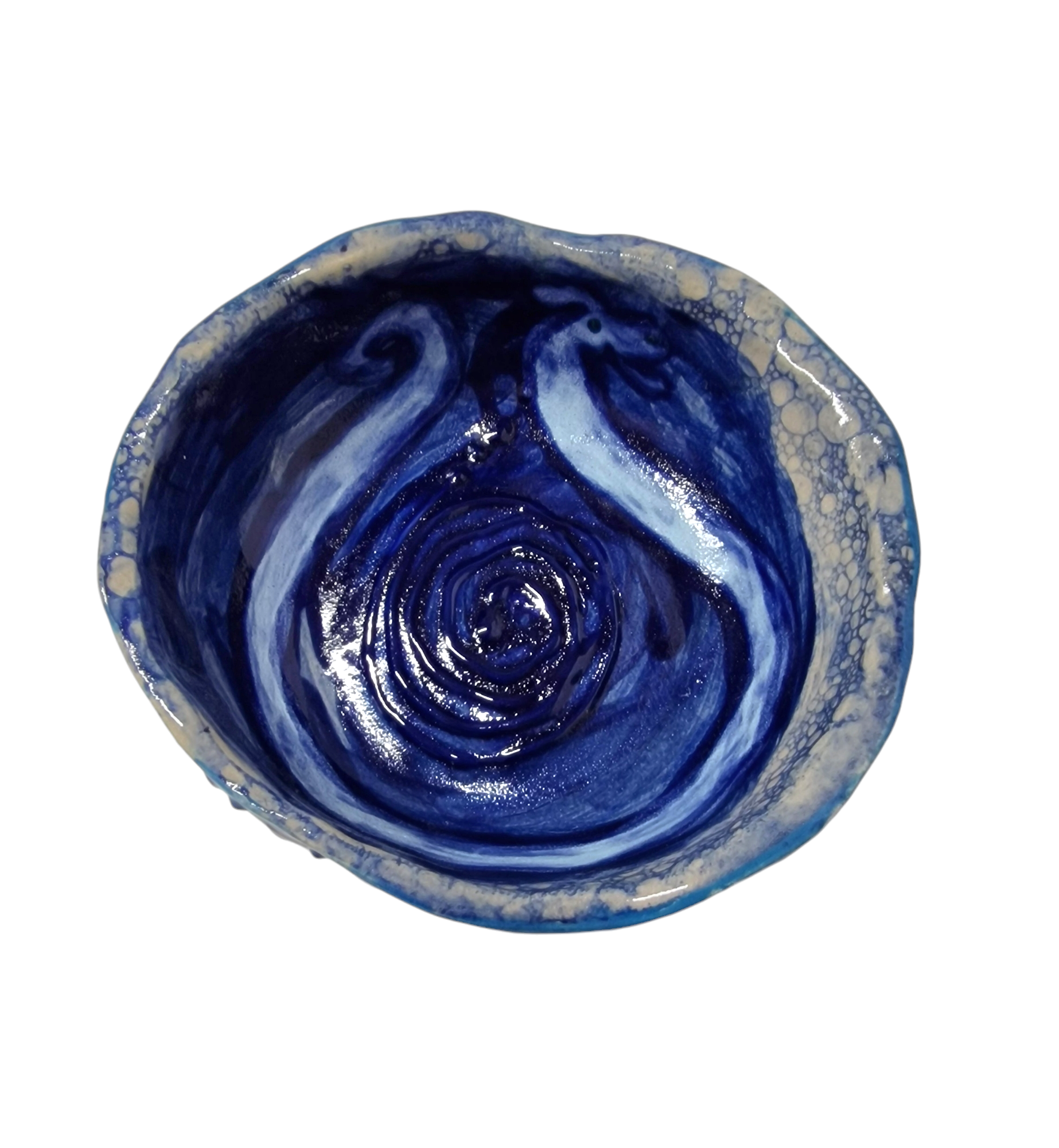 Above view of hump made stoneware bowl with blue worm like illustration in horse shoe shape