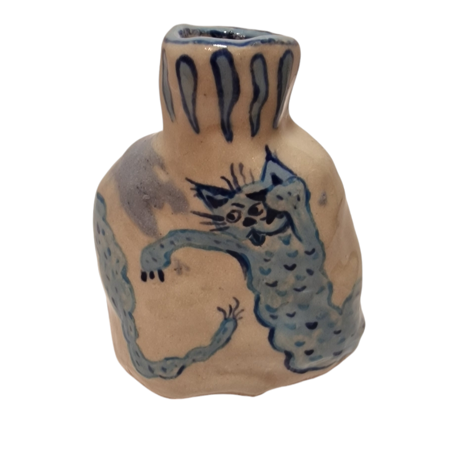 Bottle with blue cat like worm