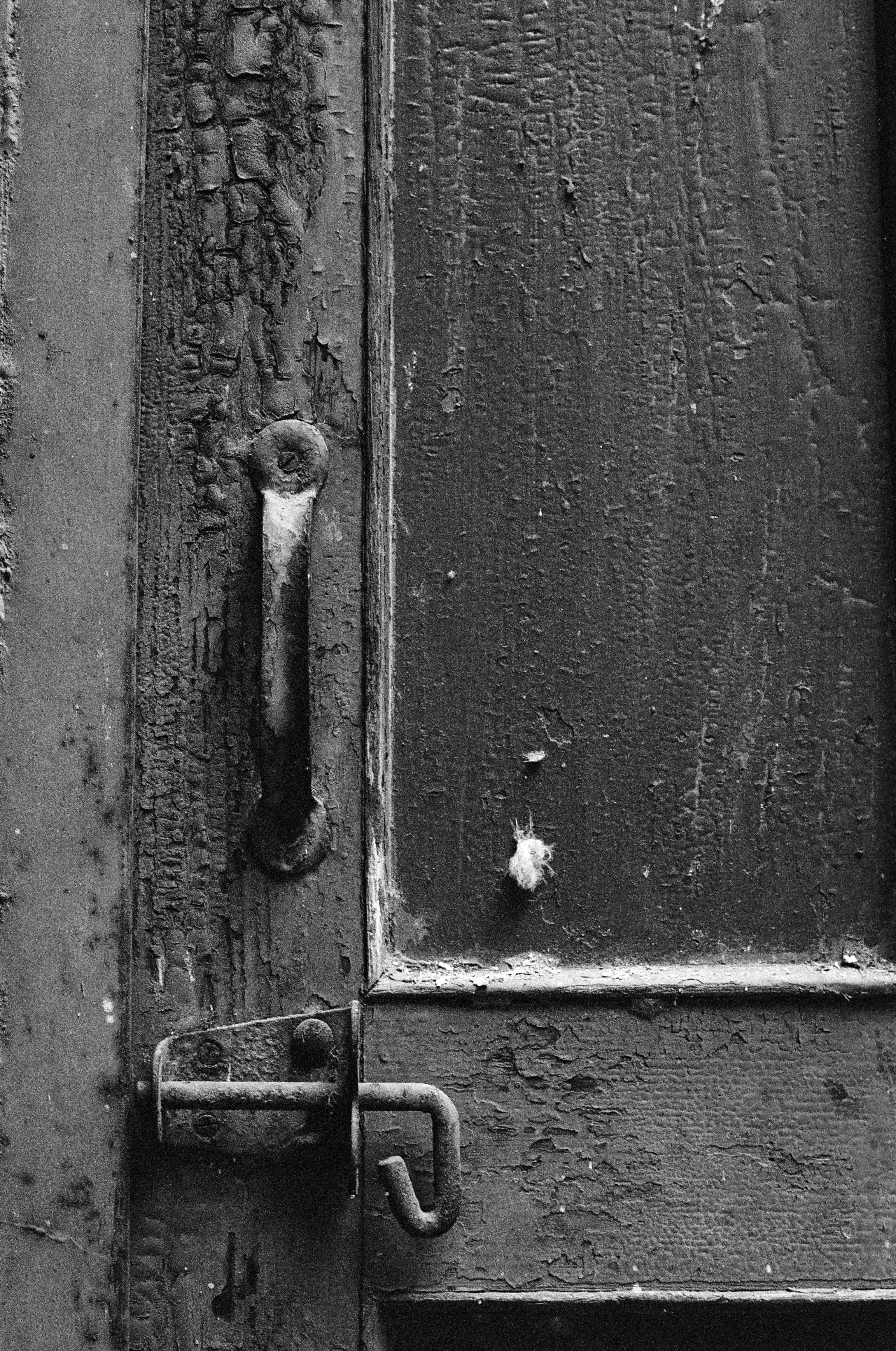 Black and white photo, close up of a door handle and lock 