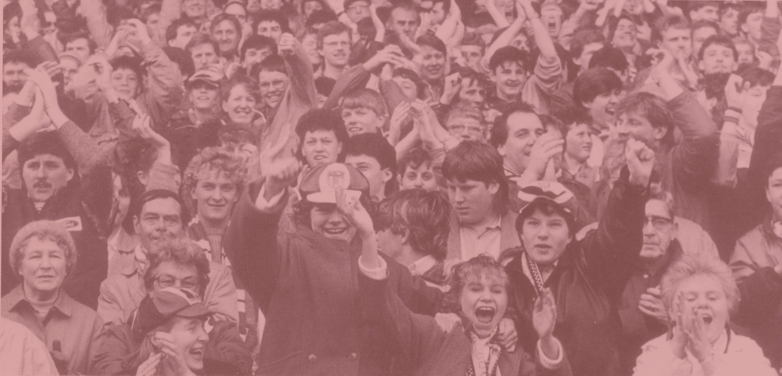 Celebrating football fans, including a small number of women fans.