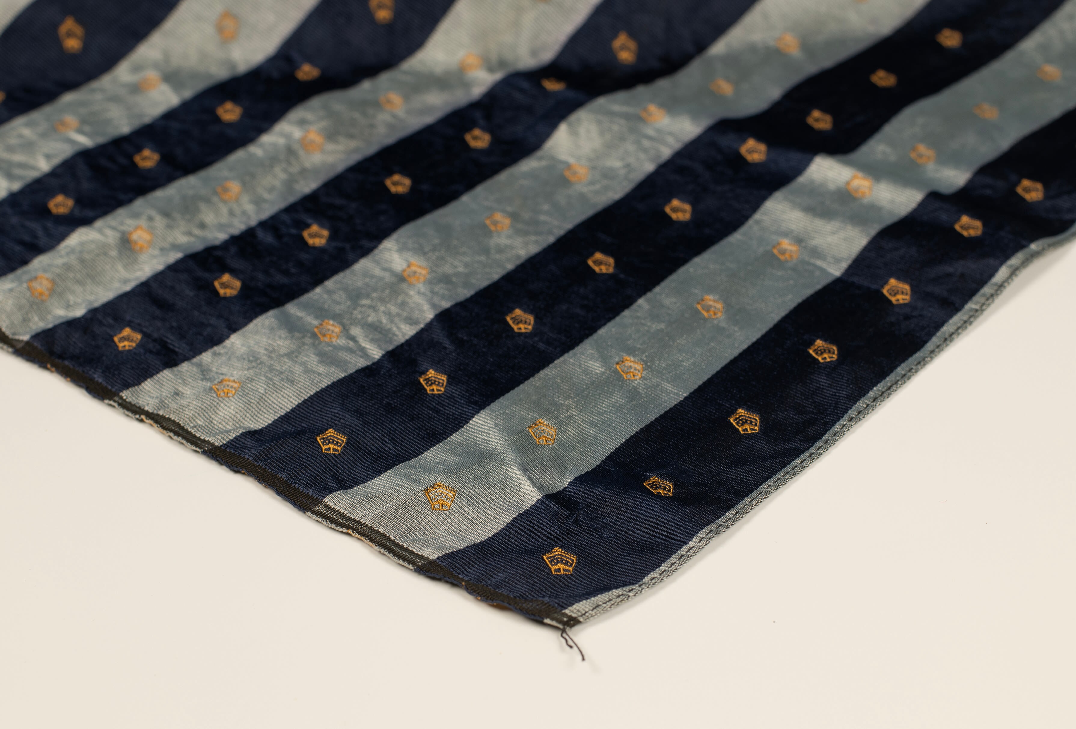 A striped blue scarf detailed with the shape of a Bishop mitre.