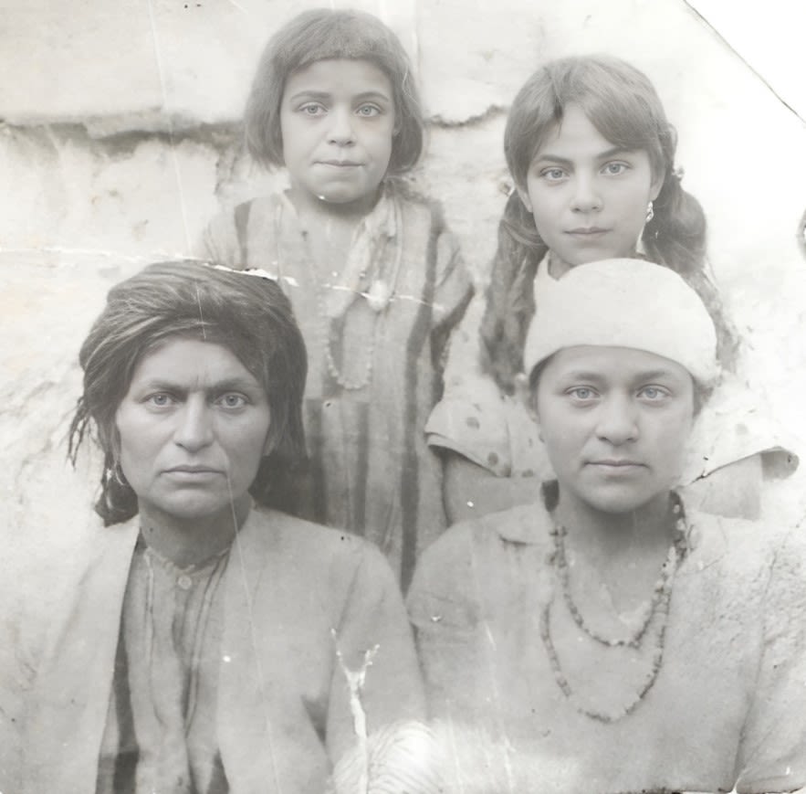 Black and white photograph, outdoors, family photograph of four people.
