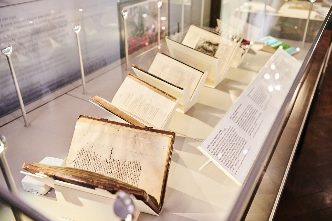 An exhibition display case filled with rare books and manuscripts