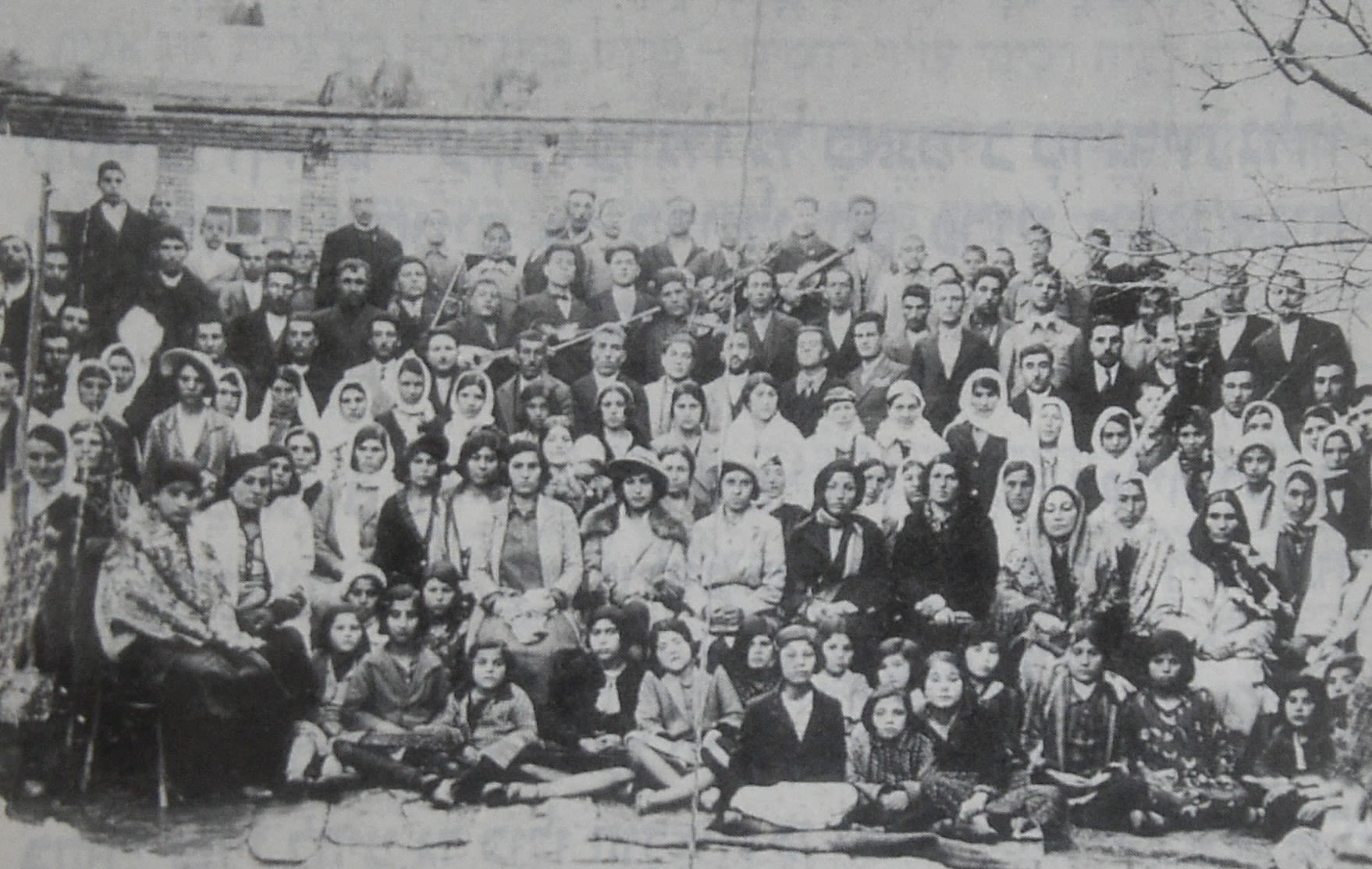 Black and white photograph of a large family group of over one hundred people.