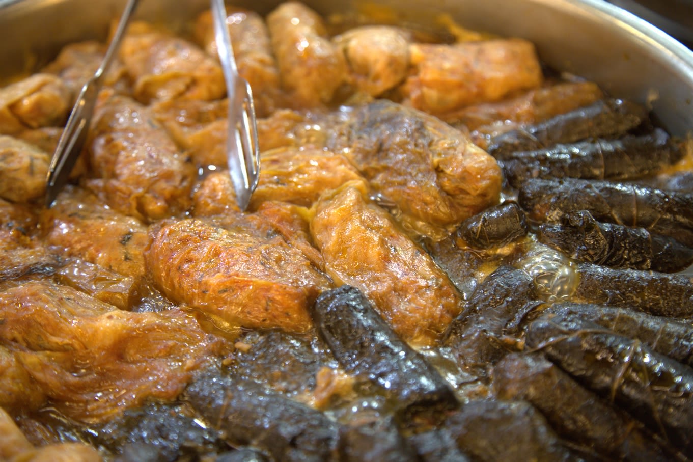 Colour photograph, indoors, two types of food in a pan, one yellow and one black.