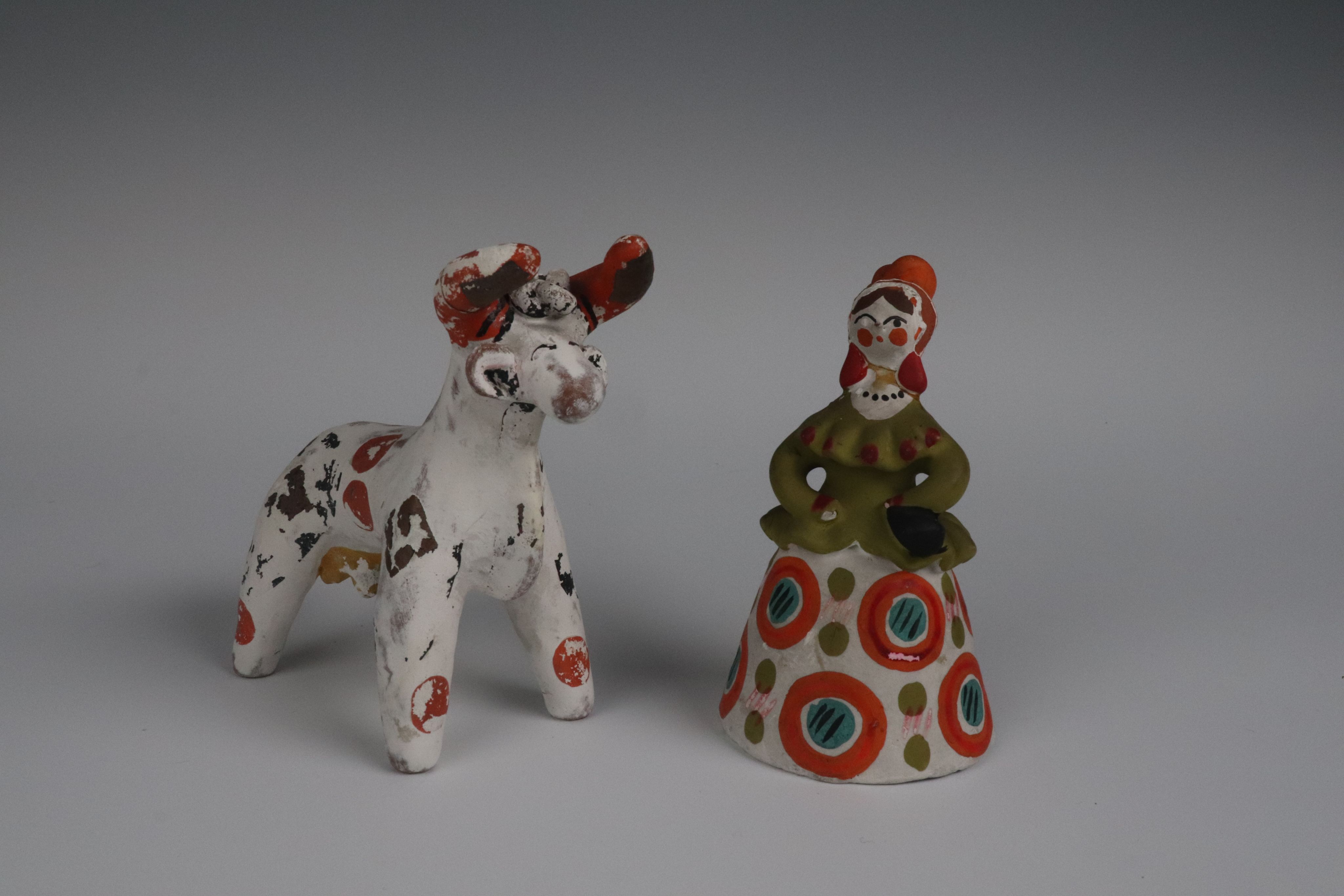 clay toys: a white animal with horns and a lady with folk clothes