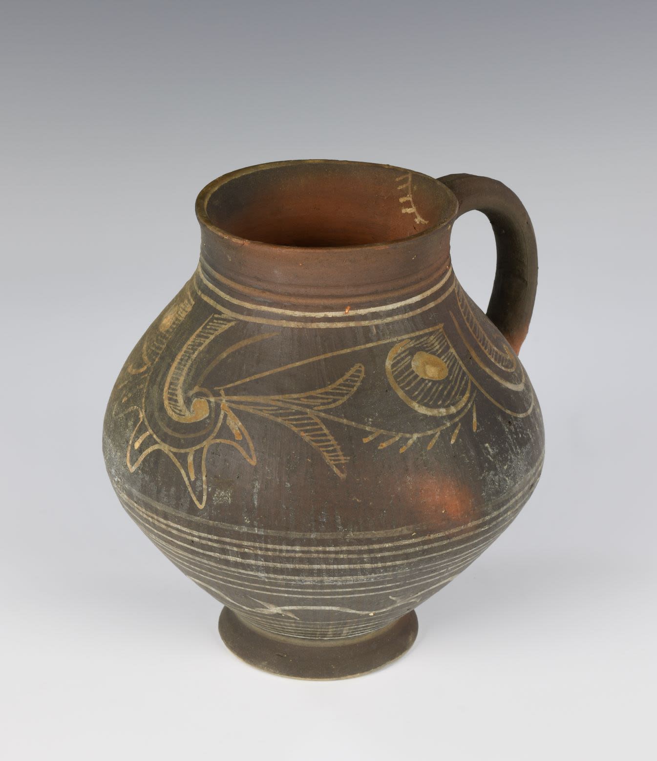 Balkhar jug decorated with traditional Balkhar patterns. The lower body is embellished with linear ornaments while the upper body comprises a mixture of floral and geometrical like patterns.