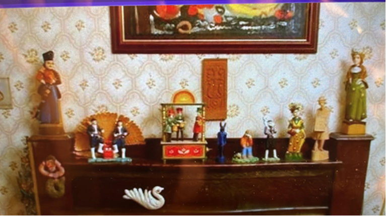 Photograph of figures on a wooden cabinet.