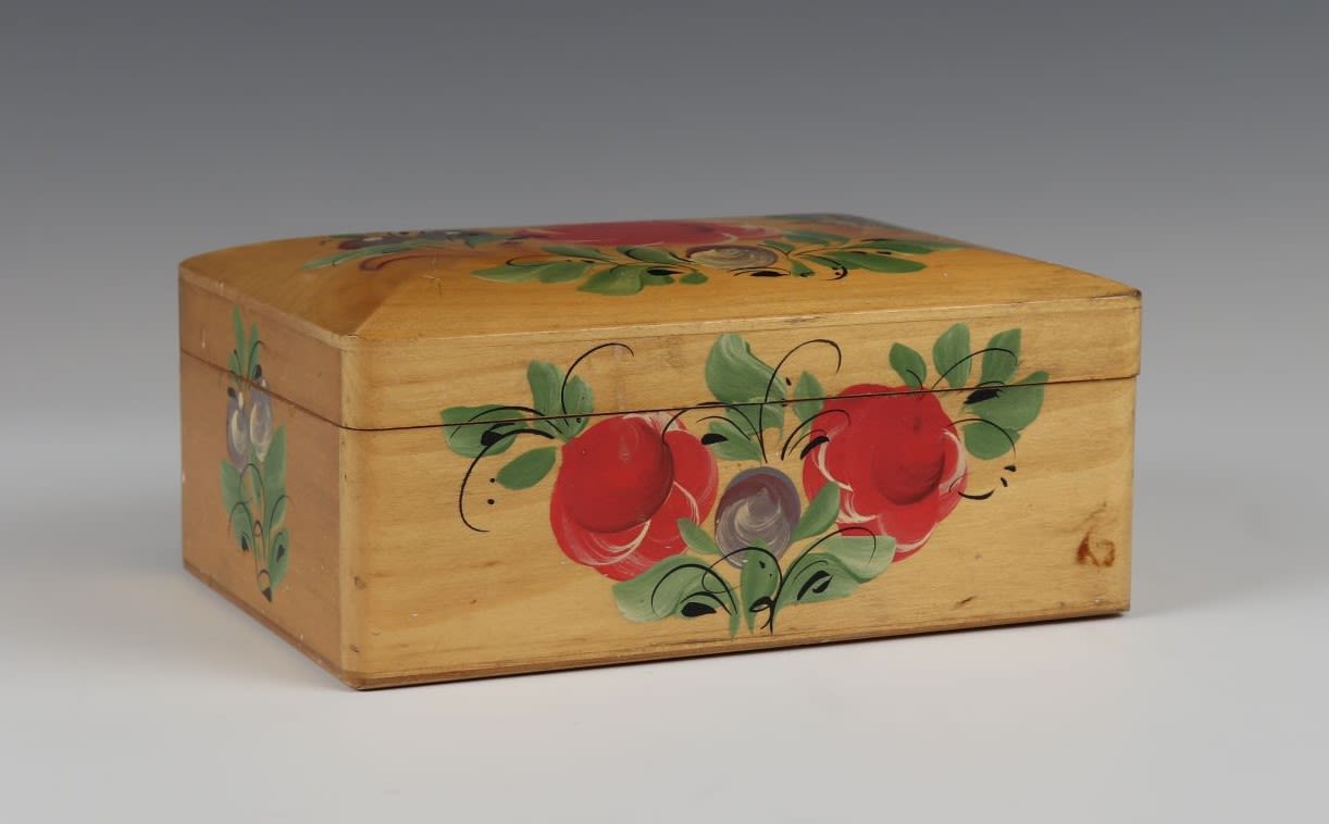 Wooden box with flower and leaf decorations in red, green and purple.