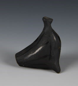 Whistle clay toy of an unrecognised figure. The toy is in matted black decorated with glossy black stripes.