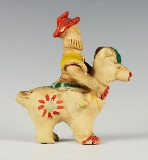 Clay rider on a big ram decorated in green, yellow and red.