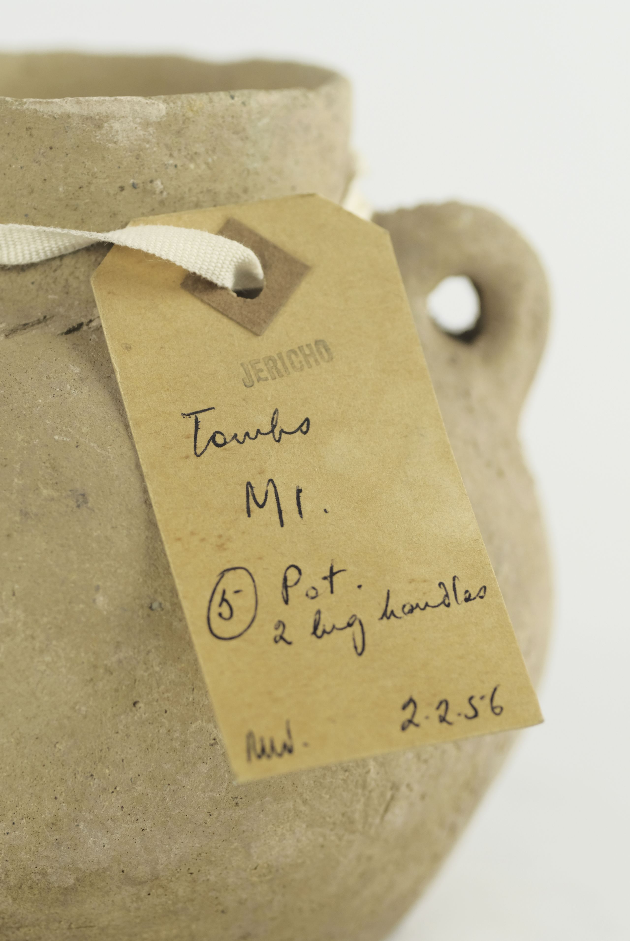 Brown tag tied to a pot stamped with “Jericho” and handwritten description