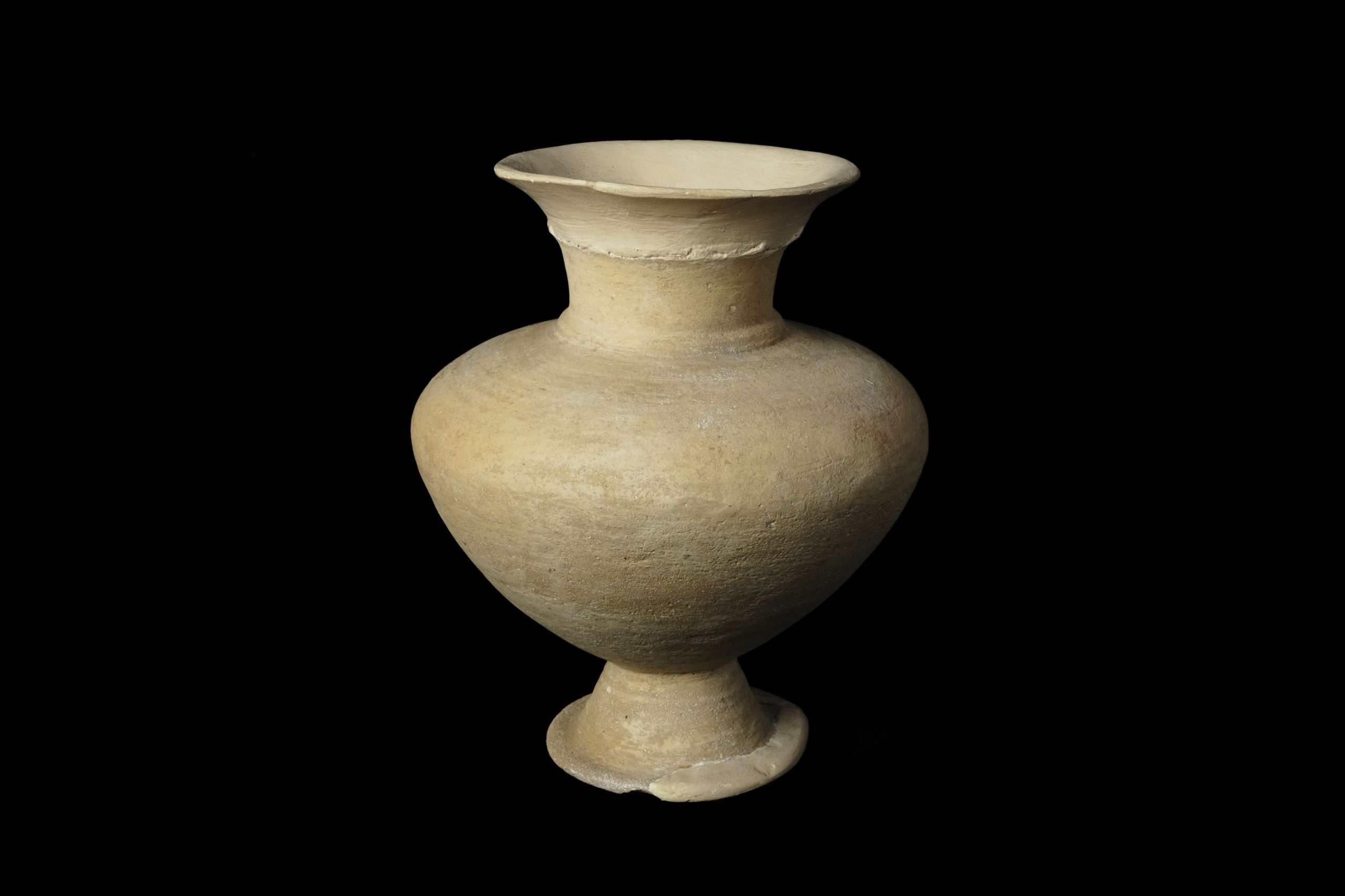 A tall, curvy orange-yellow pot wide rim and body with a narrow neck and base