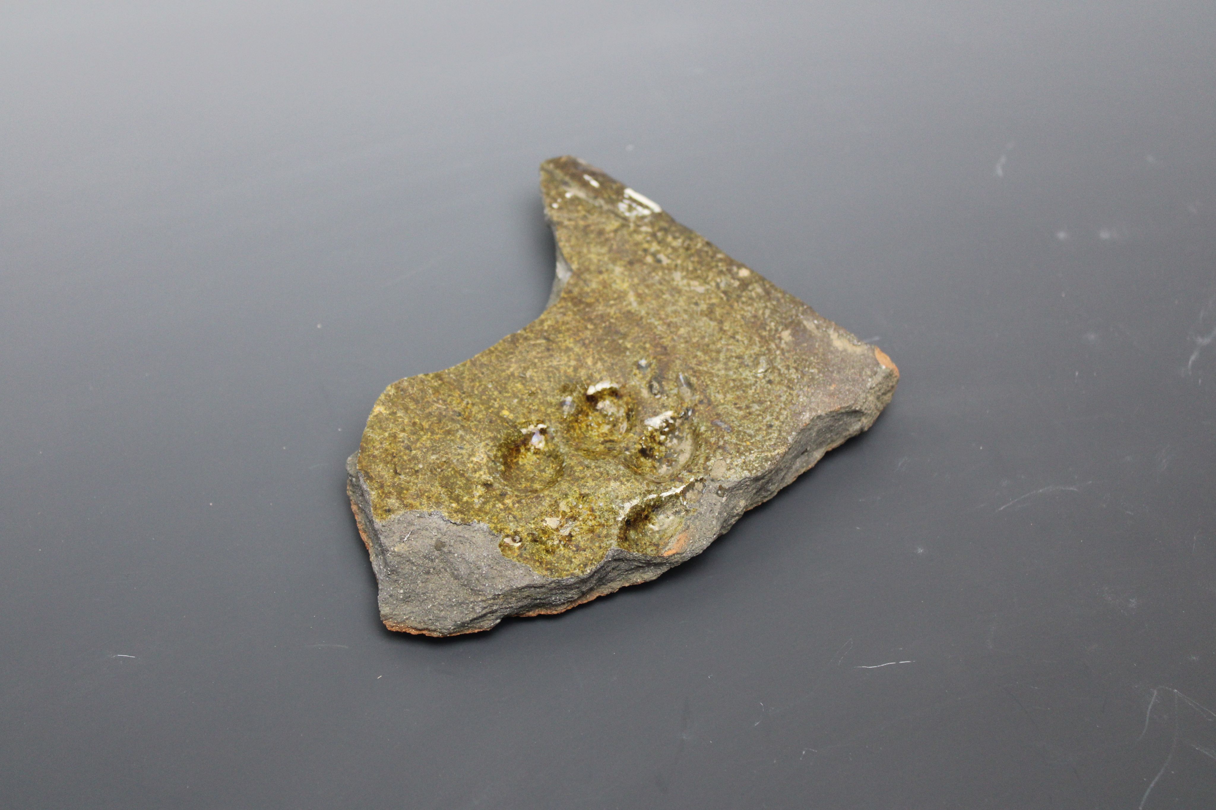 a wooden bench sitting next to a brick wall