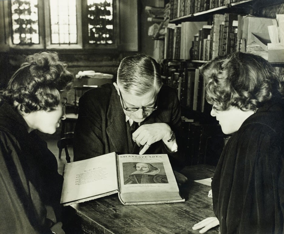 Three scholars study the title page of Shakespeare's First Folio