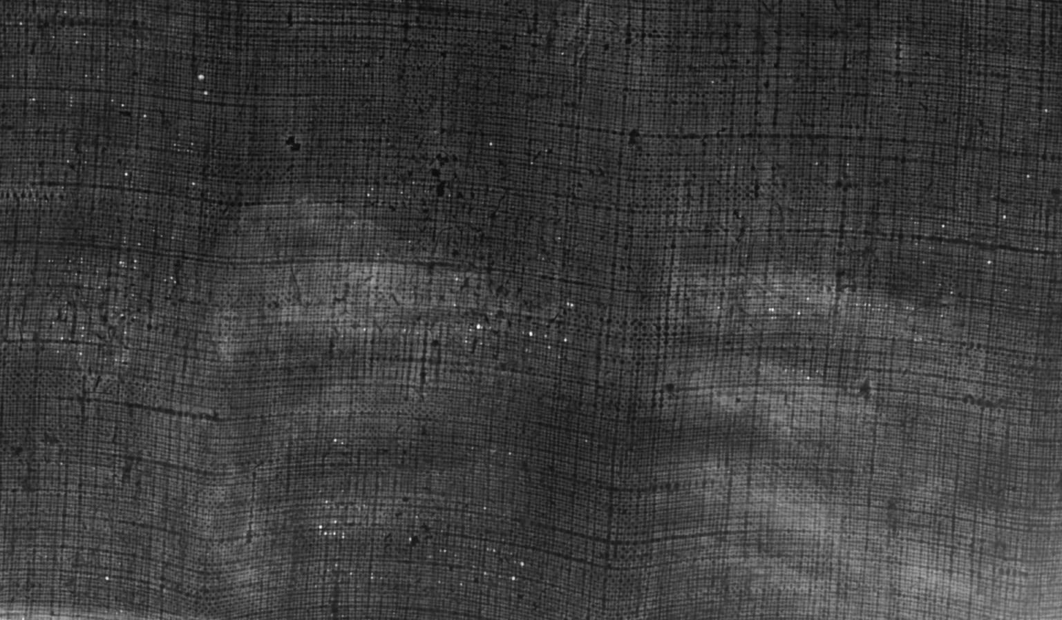 close up image focused on x-ray scan of portrait, showing Cuthbert's hands in black and white with details of painting canvas..