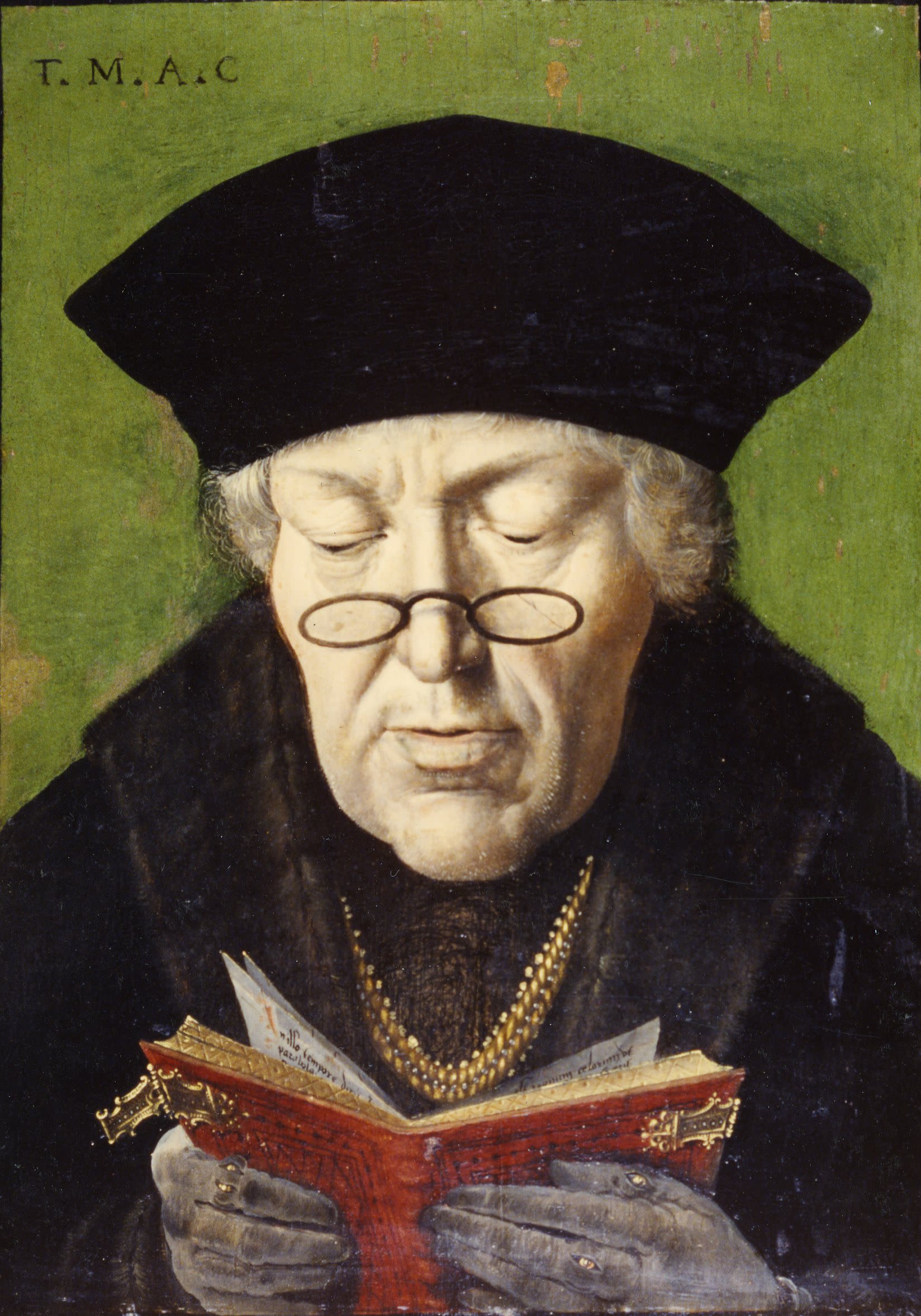 Portrait of Cuthbert as an older man, wearing a hat with small glasses perched on his nose as he looks down to read a book in his hands.