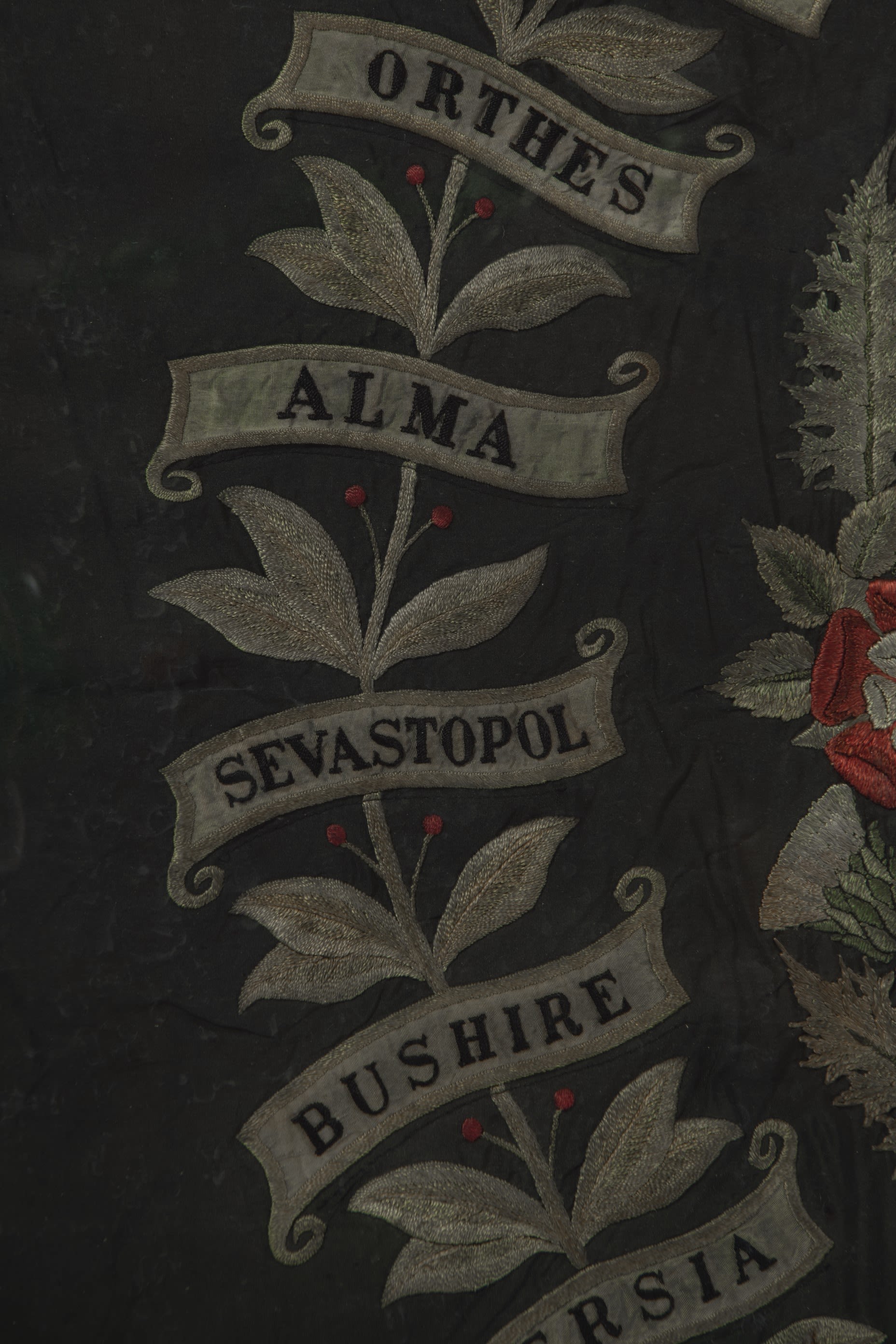 Close up photograph of a battle honour on a DLI regimental Colour. The honour displayed reads 'Alma'.